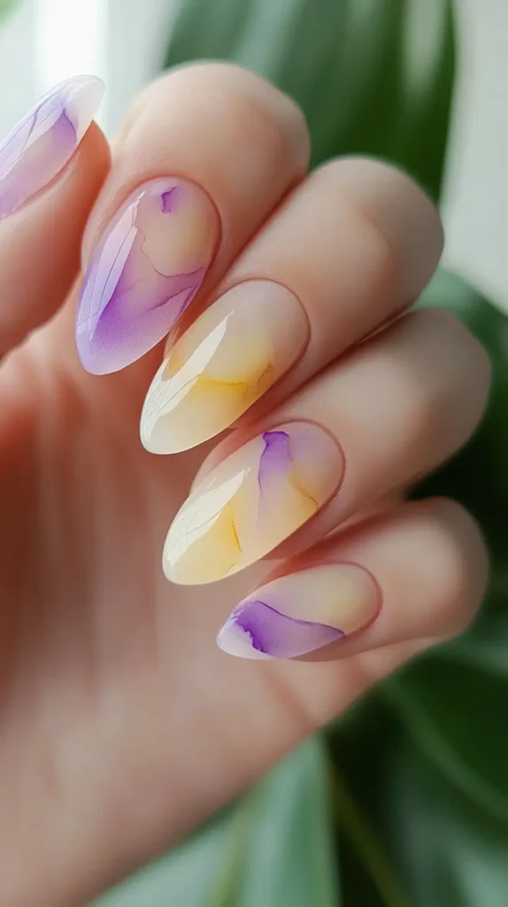 Close-up of short, naturally rounded nails painted with a semi-sheer milky white-pink polish.